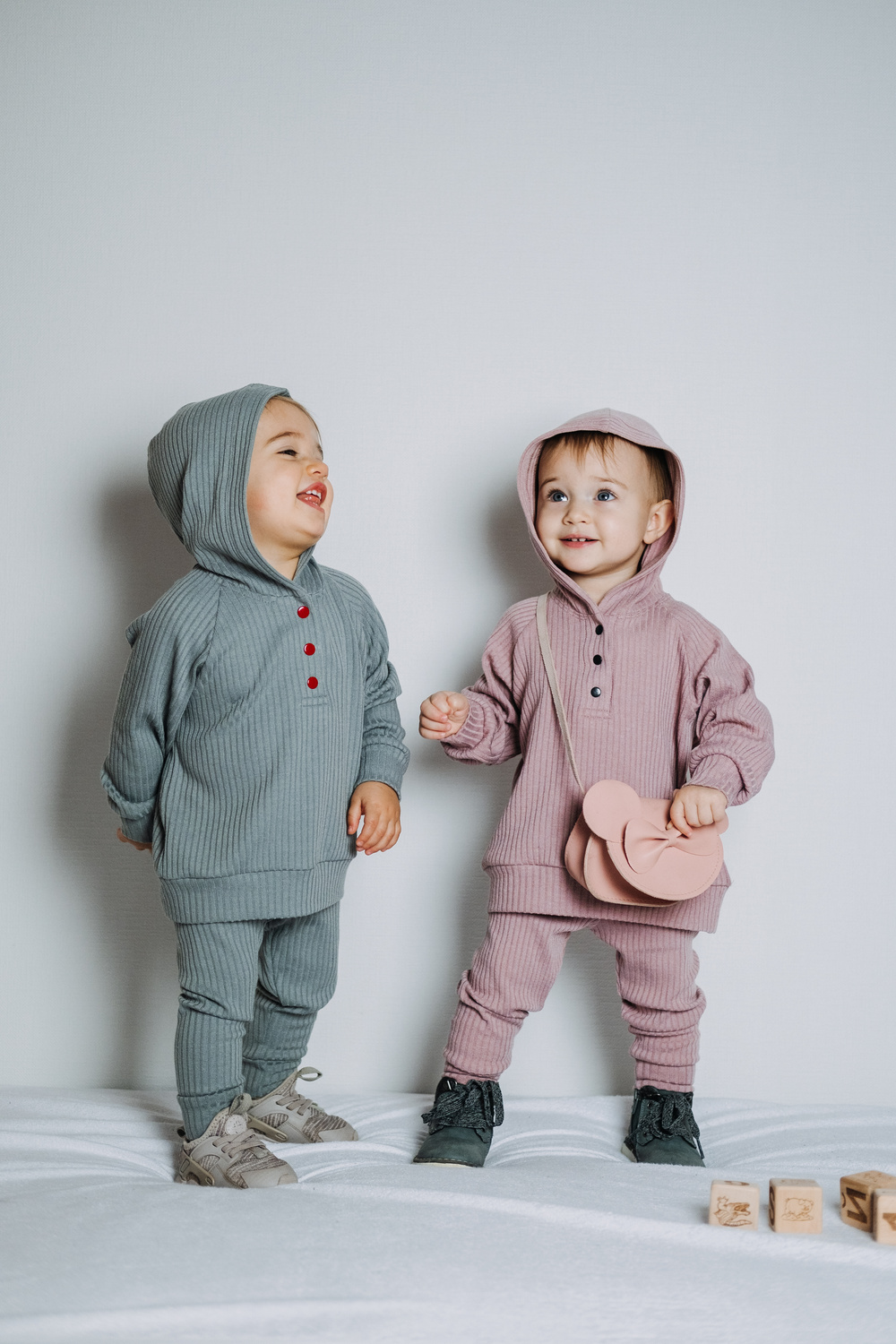 Baby fashion. Unisex clothes for babies. Two Cute baby girls
